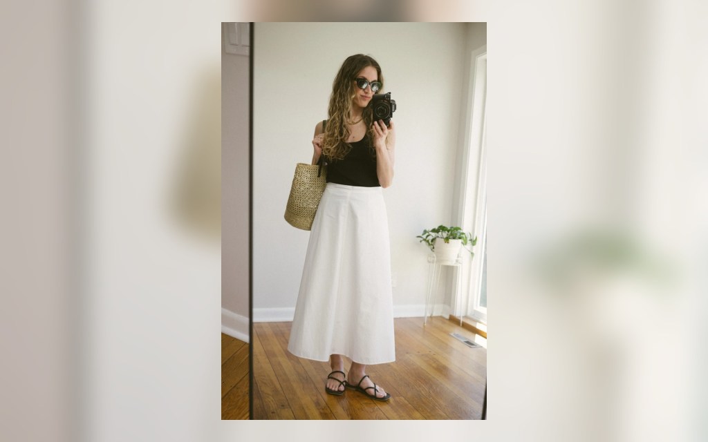 white poplin skirt styled with a black tank and flat sandals