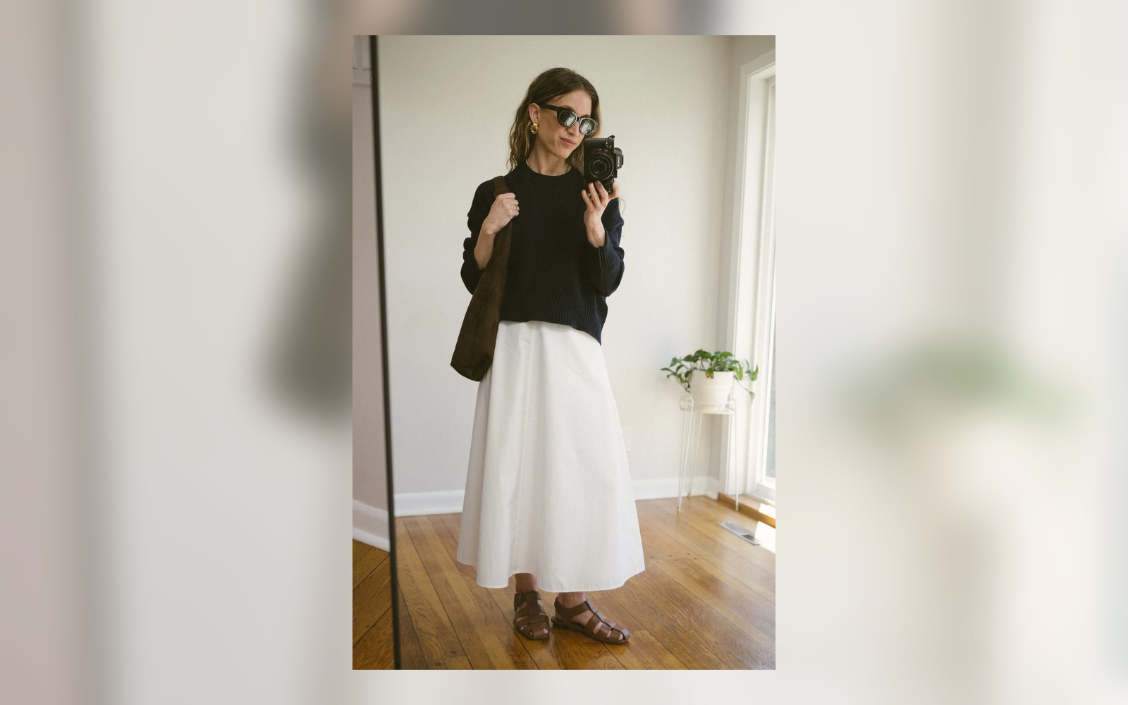 white poplin skirt styled with brown fisherman sandals