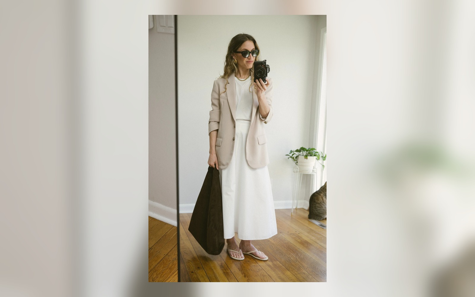 white poplin skirt styled with flat flip flops and blazer