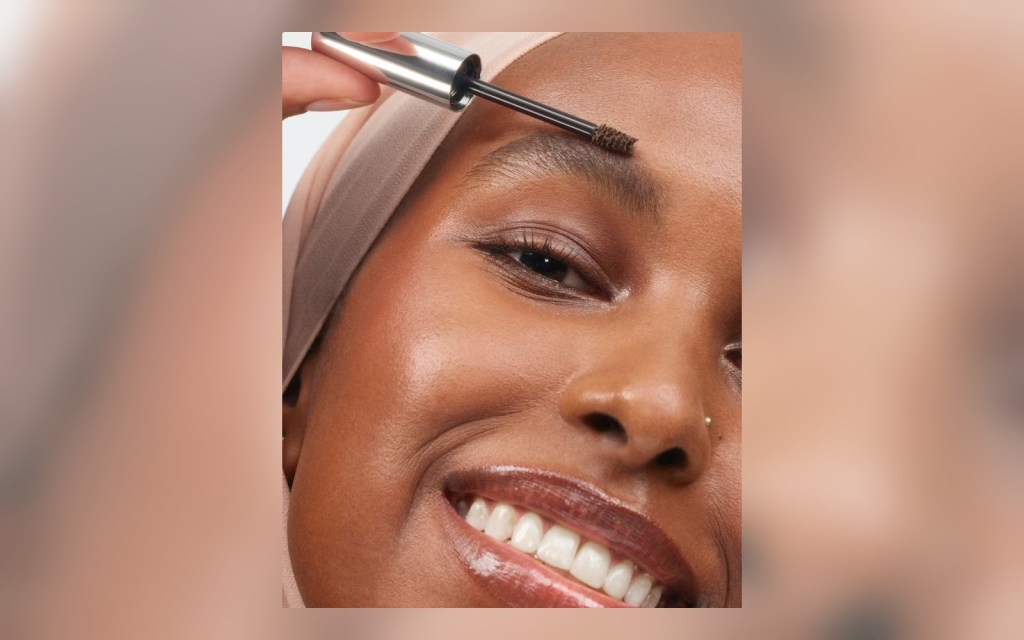 tinted brow gel brush applied through eyebrow hairs