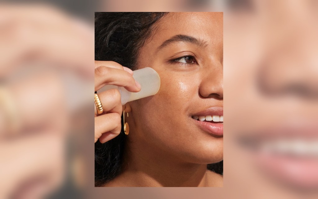 Supergoop Glow Stick sunscreen being used on skin