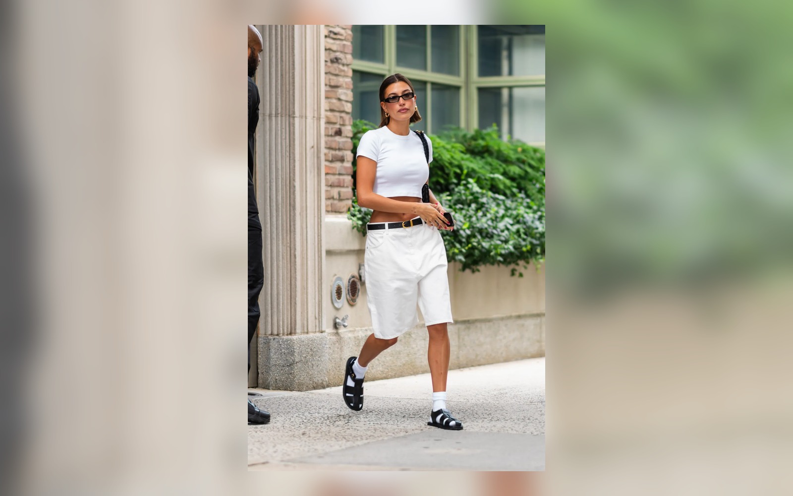 white tank and long shorts styled with black fisherman sandals