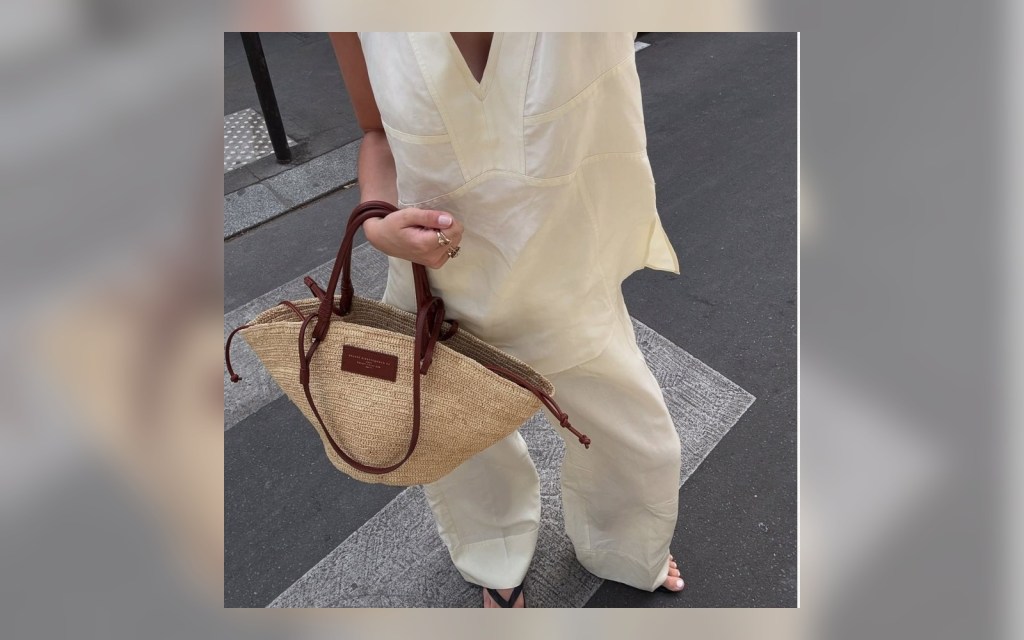 cream linen vest styled with wide-leg trousers and a woven bag