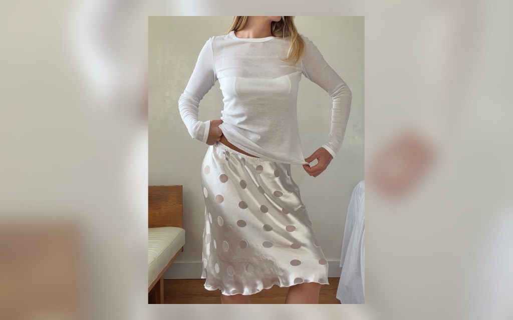 polka dot midi skirt styled with a white long sleeve top