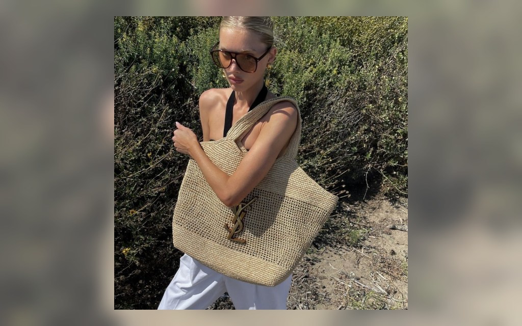 large raffia tote styled with white trousers