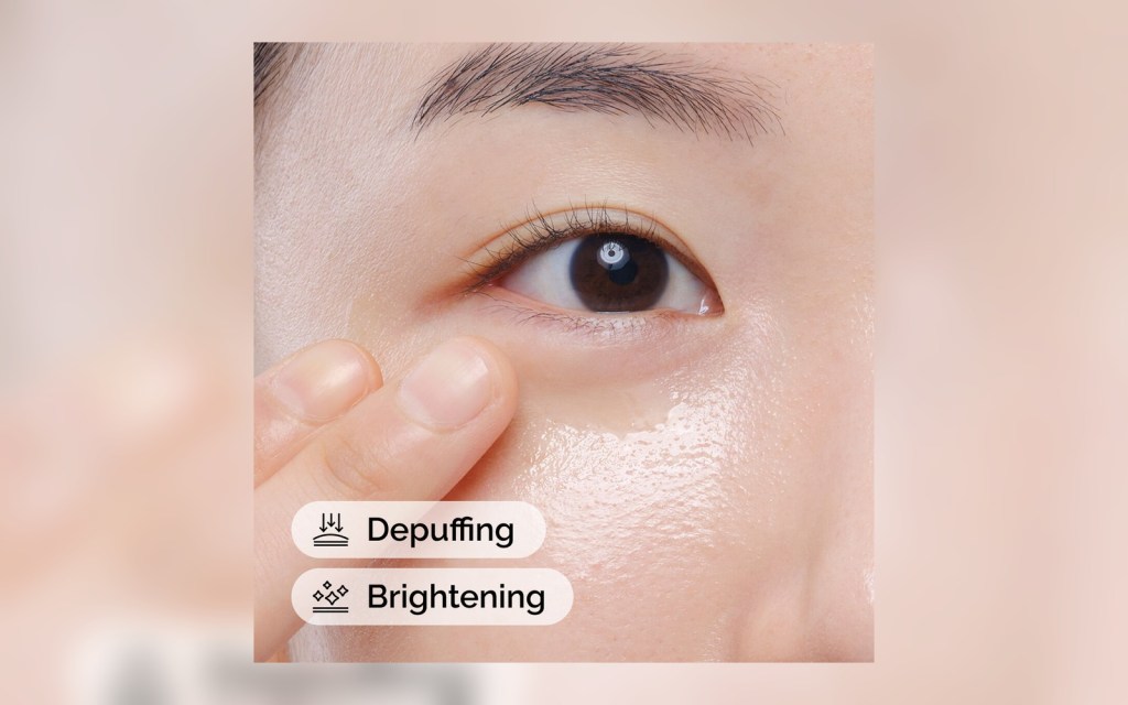 The Ordinary caffeine eye serum being applied under the eye