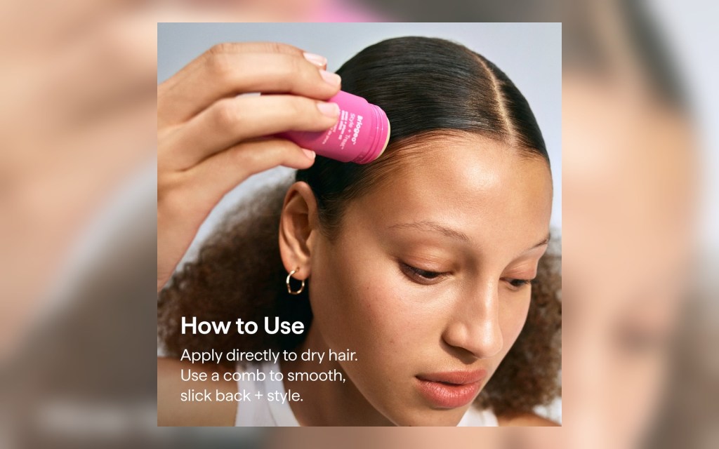 Applying a hair wax stick along the hairline to smooth flyaways.